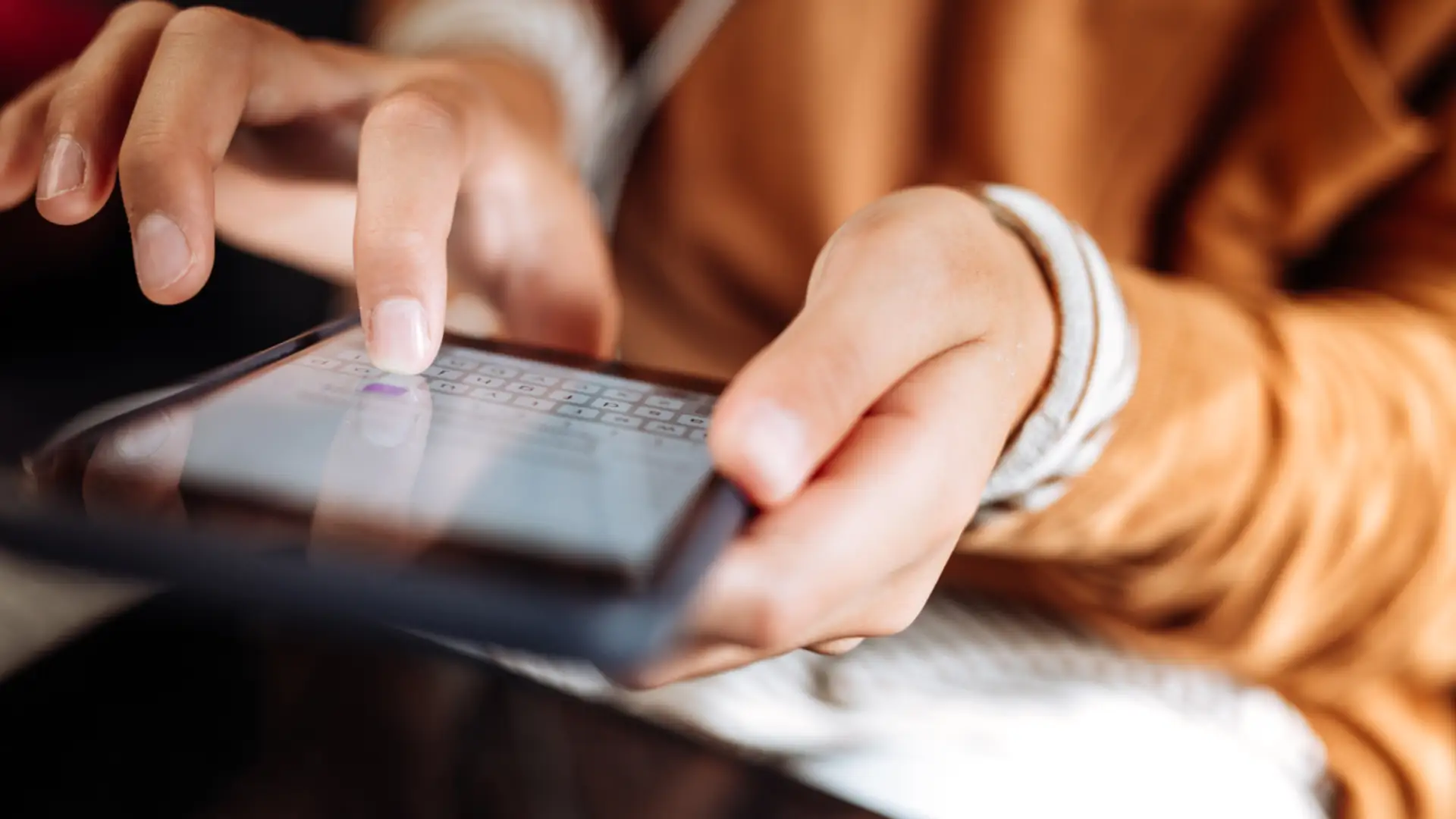 Person using a tablet to search for information online.
