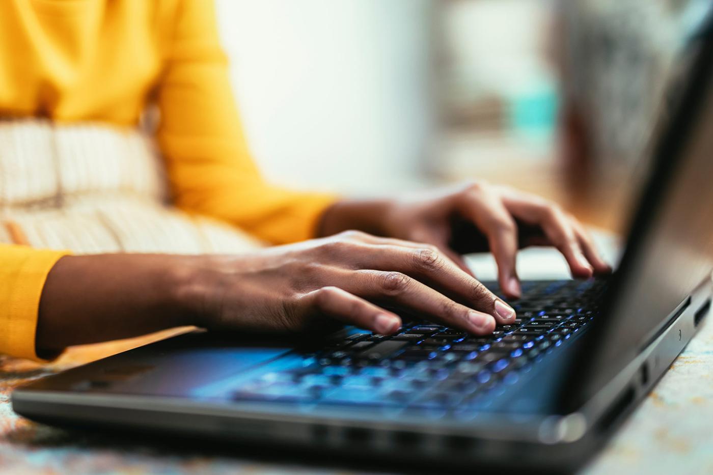 Person using a laptop to browse the internet safely and protect their online privacy.